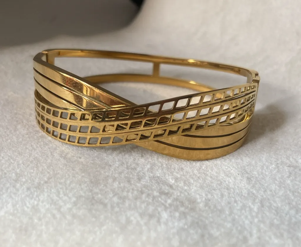 Broad gold bangle bracelet